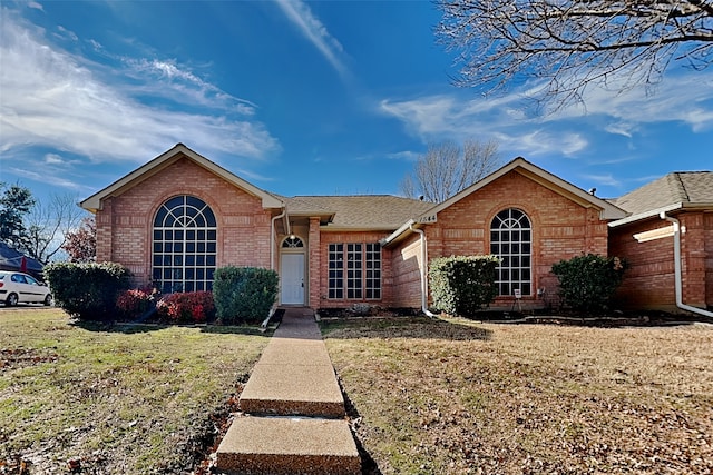 ranch-style home with a garage and a front yard