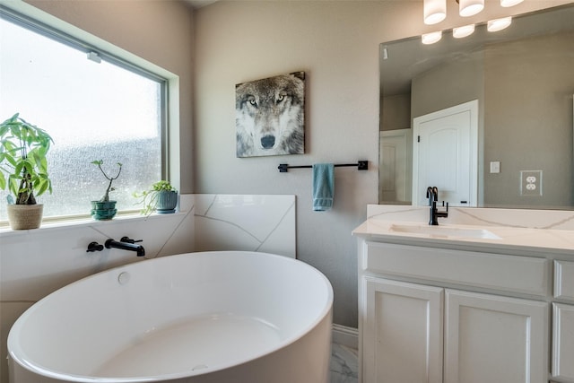 bathroom featuring a tub to relax in and vanity