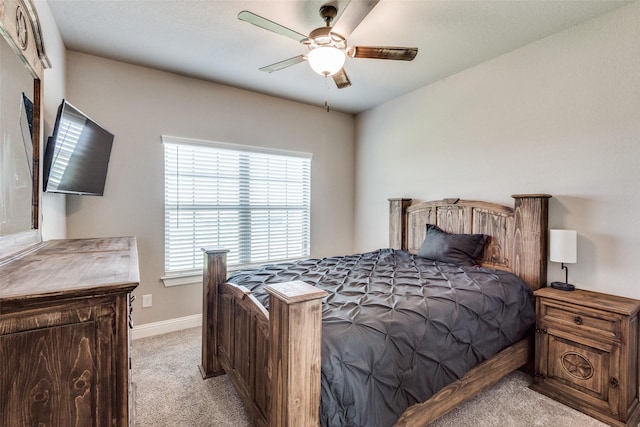 bedroom with ceiling fan and light carpet