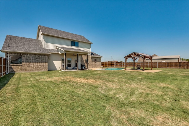 rear view of house featuring a fenced in pool, ceiling fan, a gazebo, a yard, and a patio