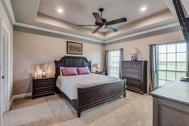 bedroom featuring multiple windows, crown molding, light colored carpet, and a raised ceiling