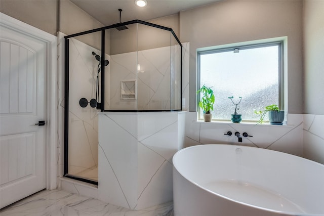 bathroom featuring independent shower and bath