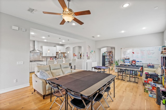 dining space featuring ceiling fan and light wood-type flooring