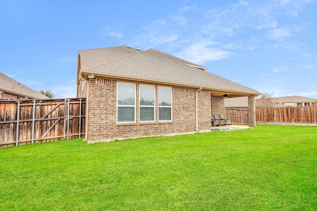 back of property featuring a patio, ceiling fan, and a lawn