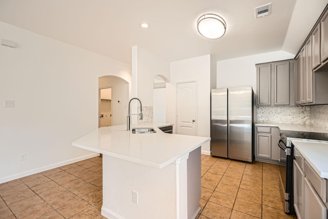 kitchen with gray cabinetry, sink, decorative backsplash, and appliances with stainless steel finishes