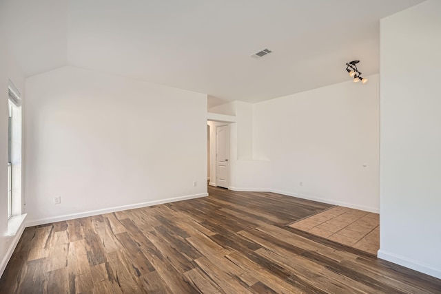 spare room with dark hardwood / wood-style floors