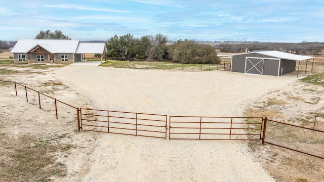 view of yard with a rural view and an outbuilding