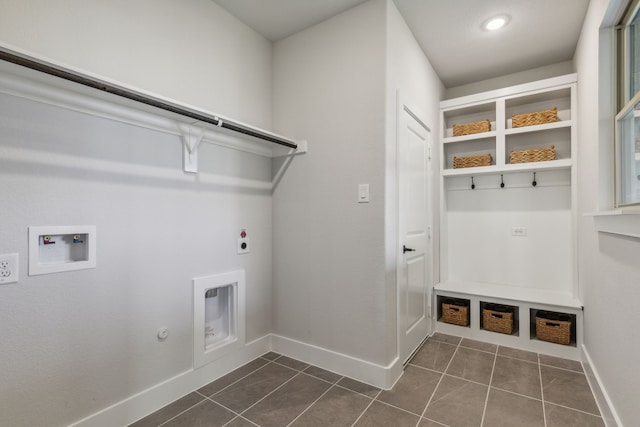 washroom featuring dark tile patterned floors, gas dryer hookup, electric dryer hookup, and hookup for a washing machine