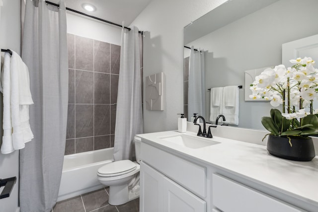 full bathroom with shower / tub combo, vanity, tile patterned floors, and toilet