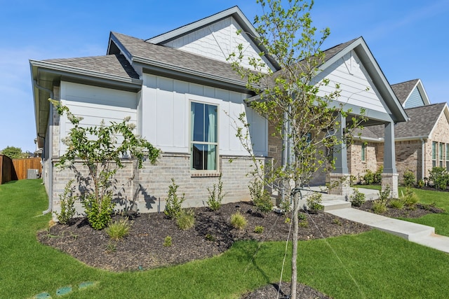 craftsman-style home with a front yard