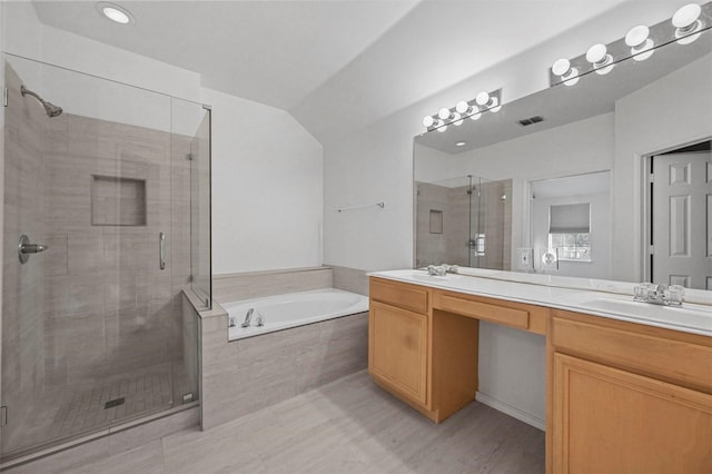 bathroom featuring vanity, lofted ceiling, and plus walk in shower