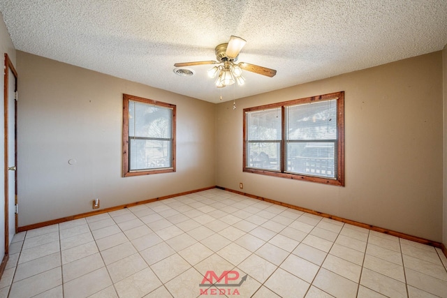 empty room with ceiling fan and a textured ceiling