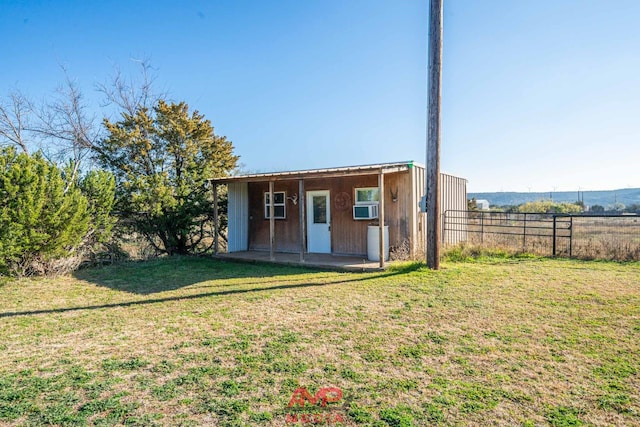 exterior space featuring cooling unit and a lawn