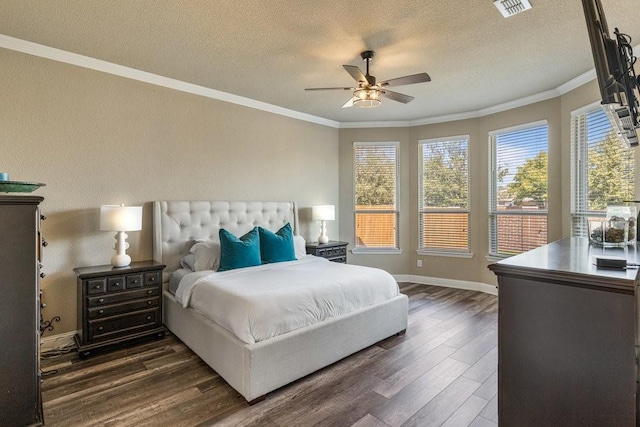 bedroom featuring crown molding, dark wood-type flooring, and a textured ceiling