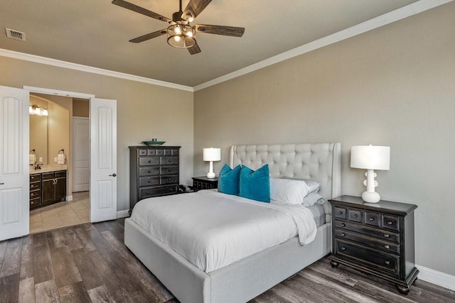 bedroom featuring ornamental molding, wood-type flooring, and ensuite bath