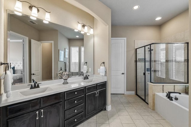 bathroom featuring vanity, tile patterned flooring, and plus walk in shower