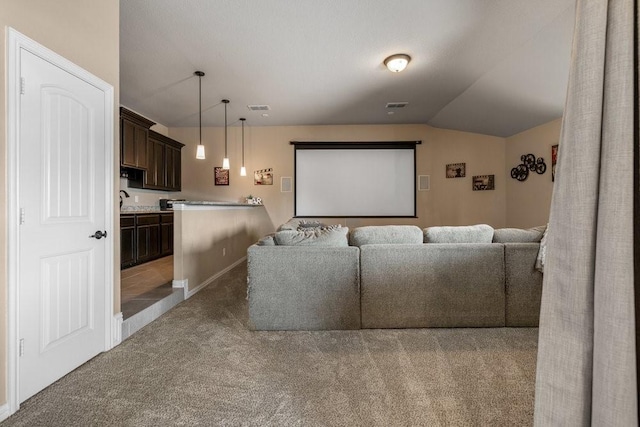 carpeted home theater room with lofted ceiling