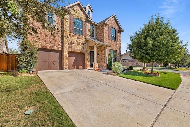 view of front of home with a garage and a front lawn