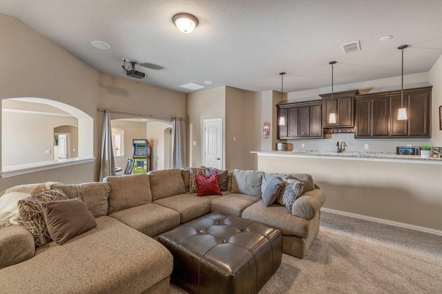 carpeted living room with a textured ceiling