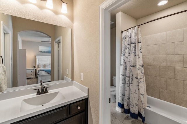 full bathroom featuring shower / bath combination with curtain, tile patterned floors, toilet, and vanity