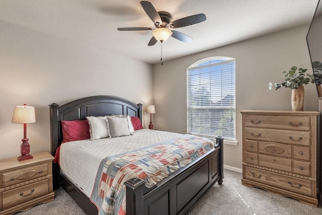 bedroom with ceiling fan and light colored carpet