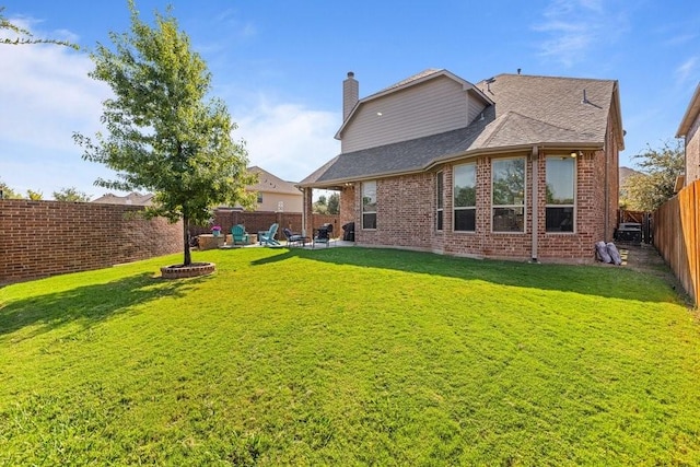 back of property with a yard and a patio area