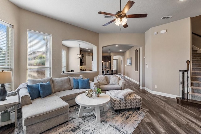 living room featuring hardwood / wood-style floors, a textured ceiling, and ceiling fan