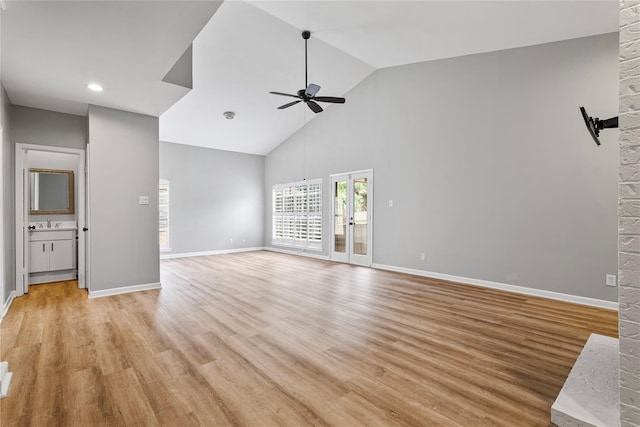 unfurnished living room with light hardwood / wood-style flooring, high vaulted ceiling, and ceiling fan