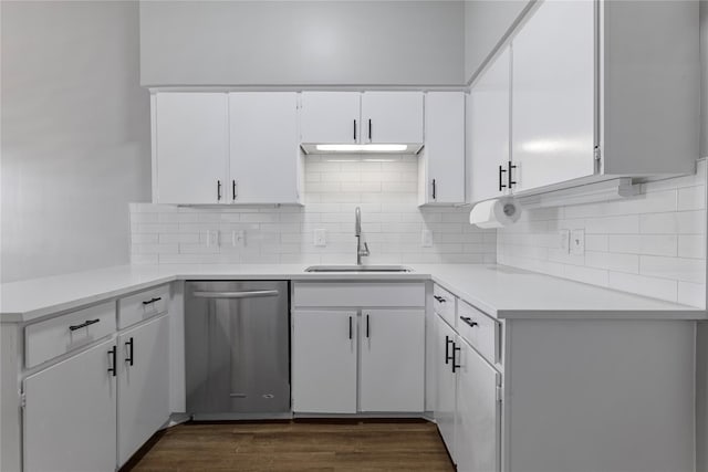 kitchen with white cabinetry, sink, backsplash, stainless steel dishwasher, and dark wood-type flooring