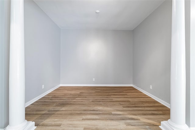 bonus room featuring light hardwood / wood-style floors and ornate columns