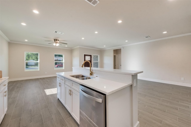 kitchen featuring an island with sink, sink, white cabinets, stainless steel dishwasher, and crown molding