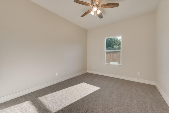 carpeted spare room featuring lofted ceiling and ceiling fan