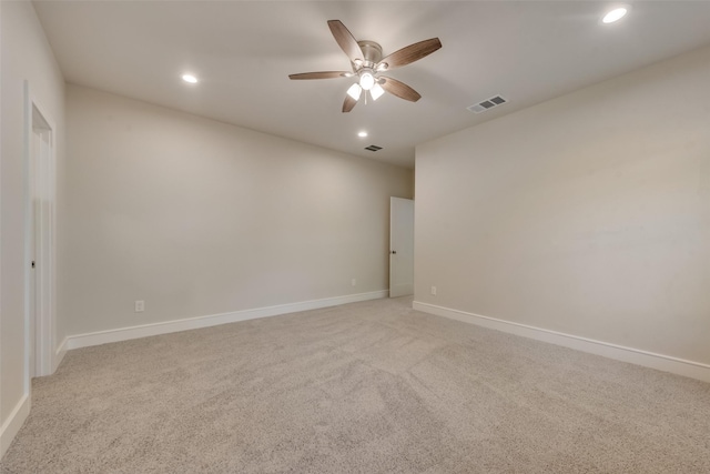 carpeted spare room featuring ceiling fan