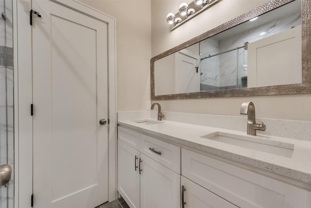 bathroom with vanity and a shower with door