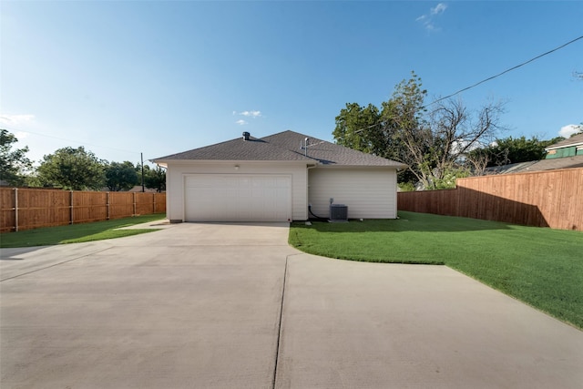 view of home's exterior featuring central AC unit, a yard, and a garage