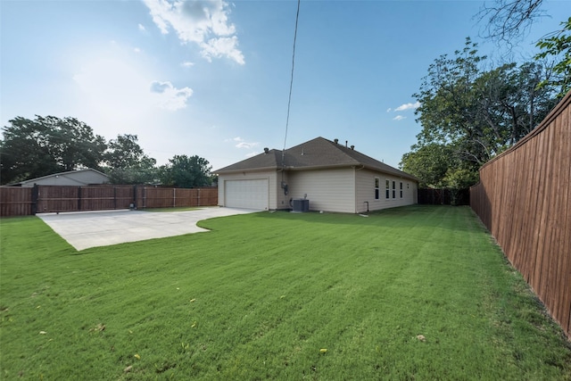 view of yard featuring cooling unit, a garage, and a patio