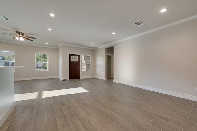 unfurnished living room featuring crown molding, ceiling fan, and light wood-type flooring