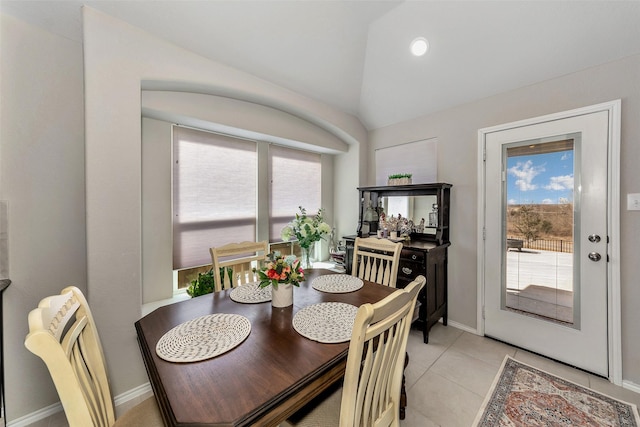 tiled dining area with lofted ceiling