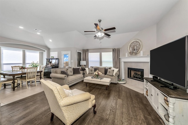 living room featuring ceiling fan, lofted ceiling, hardwood / wood-style floors, and a healthy amount of sunlight