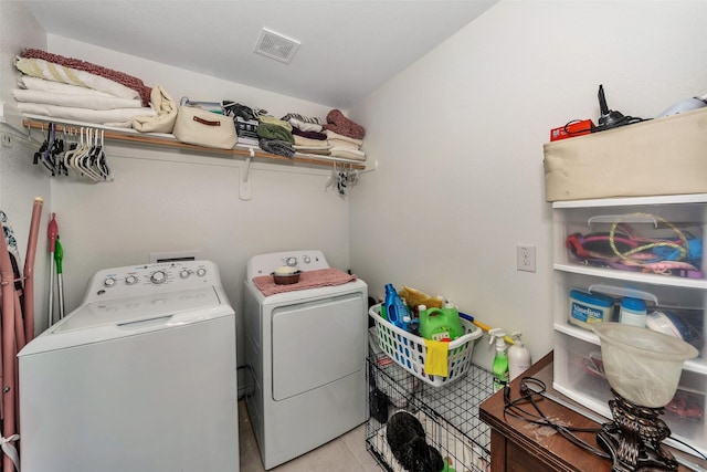 washroom with light tile patterned flooring and washing machine and clothes dryer