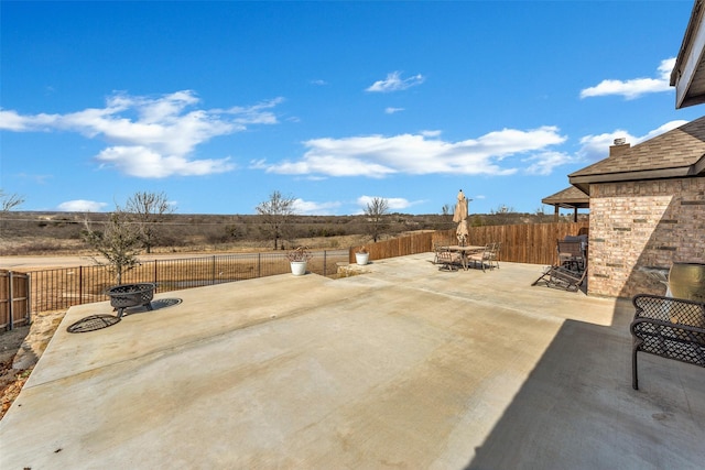 view of patio with an outdoor fire pit