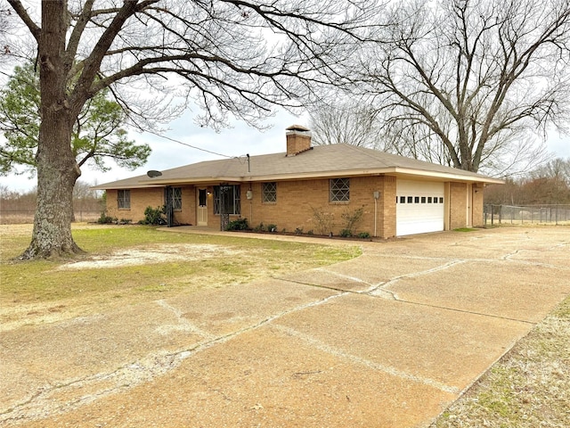 single story home featuring a garage and a front yard