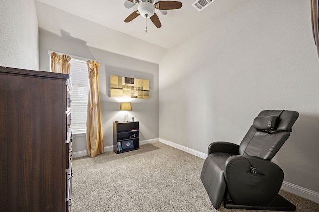 living area with light carpet and ceiling fan