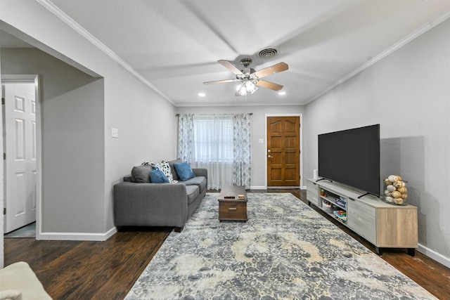 living room with dark hardwood / wood-style flooring, crown molding, and ceiling fan