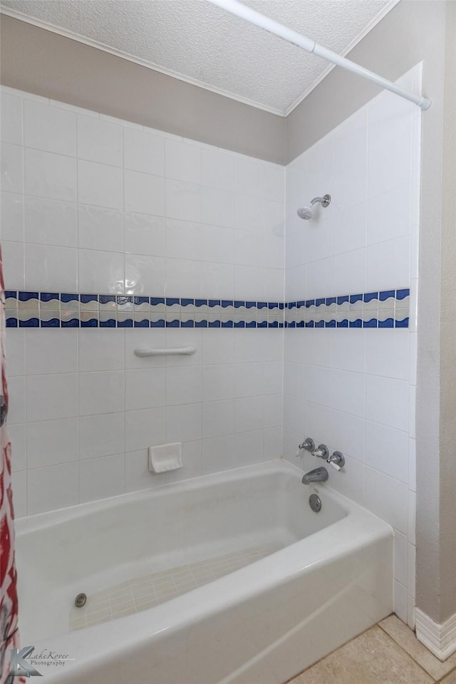 bathroom with shower / tub combo, tile patterned floors, and a textured ceiling