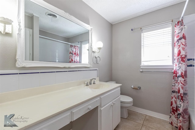 full bathroom featuring shower / bath combination with curtain, vanity, toilet, tile patterned floors, and a textured ceiling