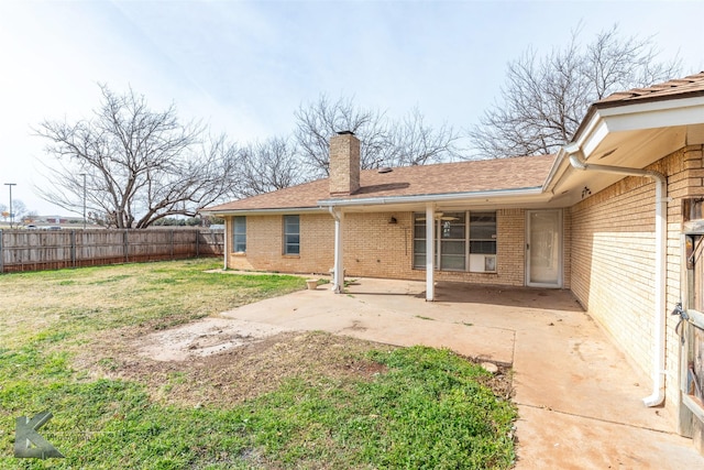 back of property featuring a yard and a patio