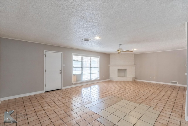 unfurnished living room with light tile patterned flooring, ornamental molding, a fireplace, and ceiling fan