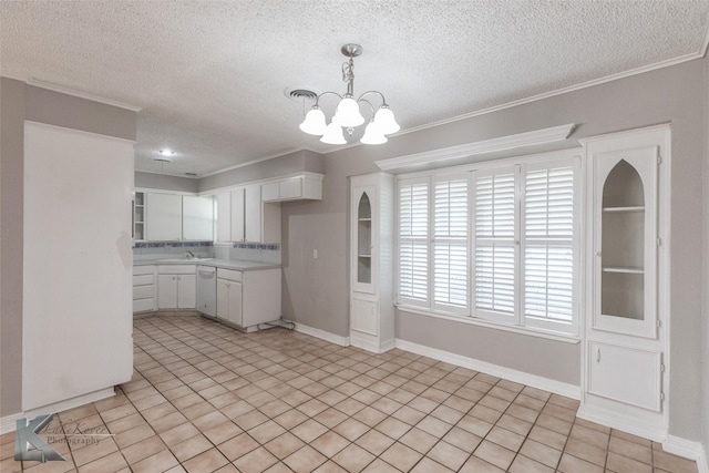 kitchen with white cabinetry, dishwasher, a chandelier, ornamental molding, and a textured ceiling