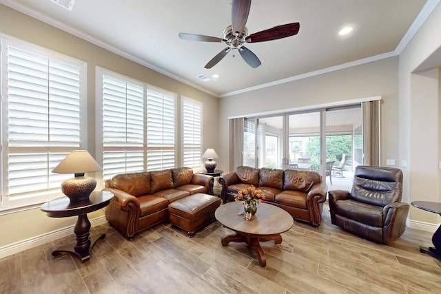 living area with crown molding, baseboards, and light wood-style floors